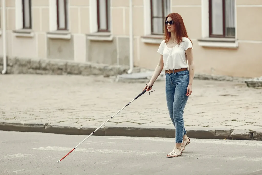 Young Blind Person With Long Cane Walking City