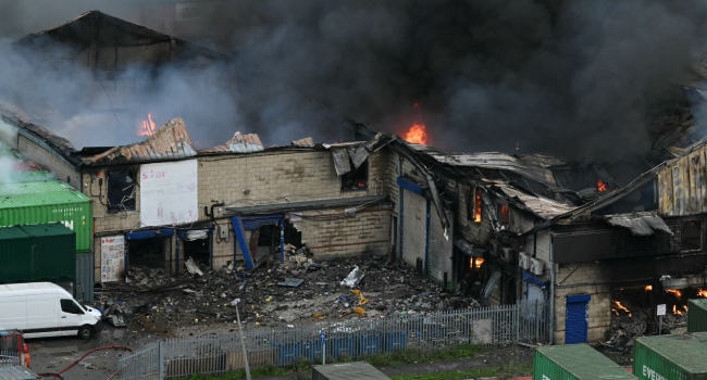 Aerial View Shows Thick Smoke Rising Into The Air As Over 100 Members Of The Fire Services Battle A Large Fire Which Broke Out At A Warehouse