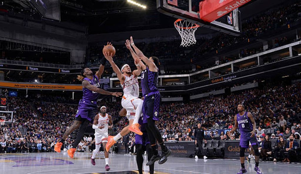 Sacramento Ca Devin Booker Of The Phoenix Suns Drives To The Basket During The Game Against
