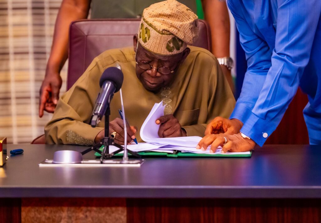 Tinubu signs Tinubu signs